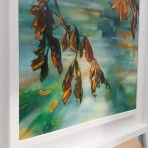 An original painting on canvas of rust and ochre coloured Autumnal tree leaves hanging over blue green water, in a bespoke off white frame.