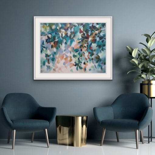 An original painting on canvas of a leafy canopy scene in soft calm grey green, mint and peach tones in a bespoke off white frame. Set against a dark blue green wall with two dark velvet occasion chairs and gold side table.