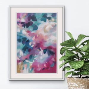 A Softly blended pink and blue abstracted leafy tree canopy painting in a bespoke white frame, set against a pale white wall with a potted plant in front. From the Canopy Series by Irish nature artist Eibhilin Crossan