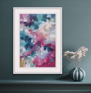 A Softly blended pink and blue abstracted leafy tree canopy painting in a bespoke white frame, set against a dark grey green wall over a shelf with a pot of dried flowers. From the Canopy Series by Irish nature artist Eibhilin Crossan