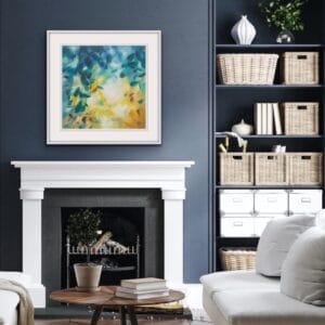 An original painting on canvas of a leafy canopy scene in mellow autumnal gold and green shades, in a bespoke off white frame. Set on a dark blue wall over a white fireplace in a cosy living room with a white couch and coffee table.