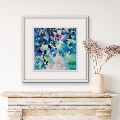 An original painting on canvas of leafy trailing plants in cool blue and green shades, with a pop of fuchsia pink, in a bespoke off white frame. Set against a pale wall above a wooden fireplace mantel with a vase of dried flowers.