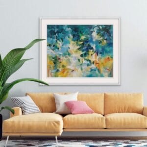 An original painting on canvas of a leafy canopy scene in vibrant summer yellows, greens and blues in a bespoke with frame. Set on a light coloured wall over a warm sunflower yellow velvet couch.