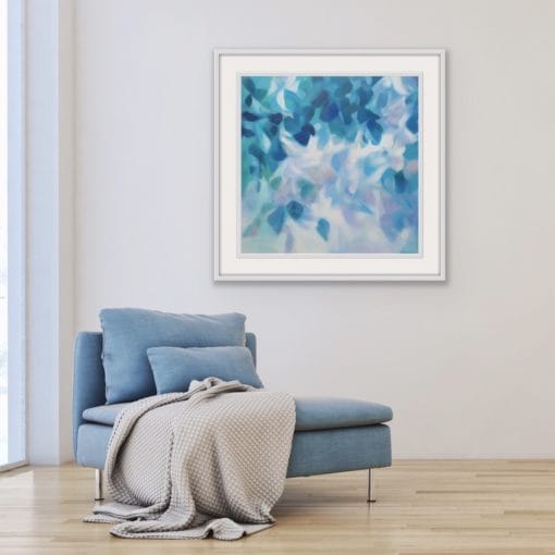 Blue leafy tree canopy monochromatic painting from the Canopy Series by Irish nature artist Eibhilin Crossan. With blue chair and beige throw,