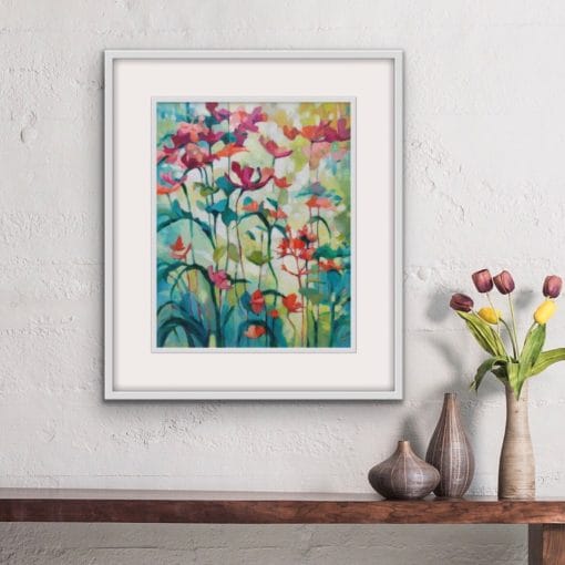 Colourful floral original painting in a white frame of peach flowers growing tall in a garden by Irish nature artist Eibhilin Crossan. A painting set against a beige wall with a wooden console table with a vase of tulips.