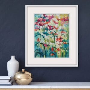 Colourful floral original painting in a white frame of peach flowers growing tall in a garden by Irish nature artist Eibhilin Crossan. A painting set against dark navy blue wall with a white marble console table.