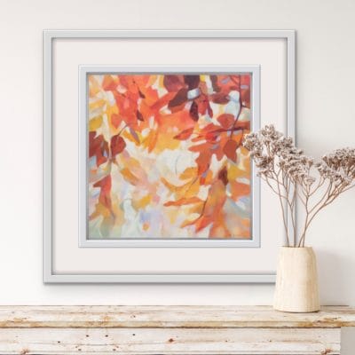 An original painting on canvas of a leafy canopy scene in mellow autumnal orange, gold and brown shades, in a bespoke off white frame. Set against a light coloured wall over a wooden mantel with a vase of dried flowers.